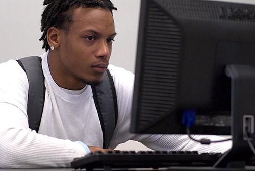 Male student working at a computer